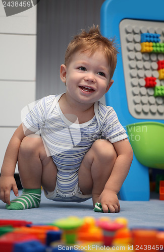 Image of A happy baby boy on a floor