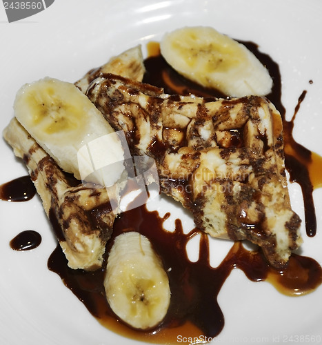 Image of Waffles With Bananas And Chocolate Syrup