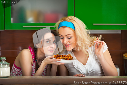 Image of Girls try the freshly cooked homemade cookies