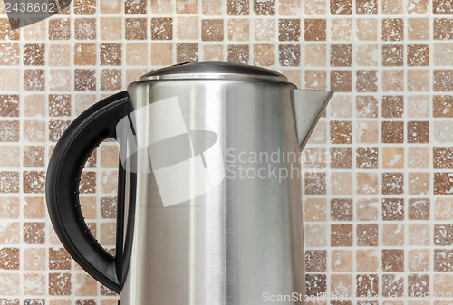 Image of Electric kettle on kitchen tile background