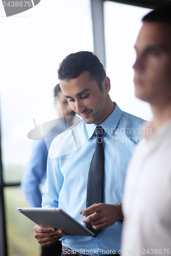 Image of business man using tablet compuer at office