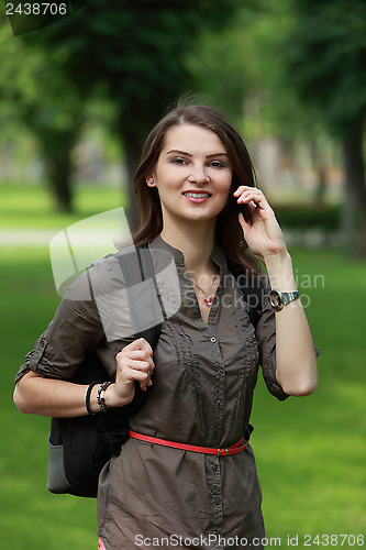 Image of Young Woman on the Phone in a Park