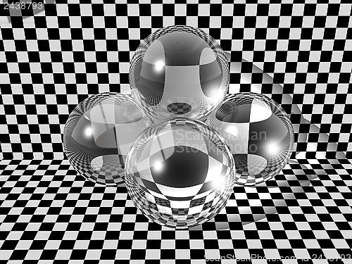 Image of Three glass balls on checkerboard background
