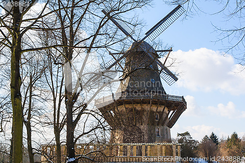 Image of Old wind mill at the winter forest landscape