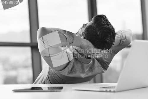 Image of happy young business man at office