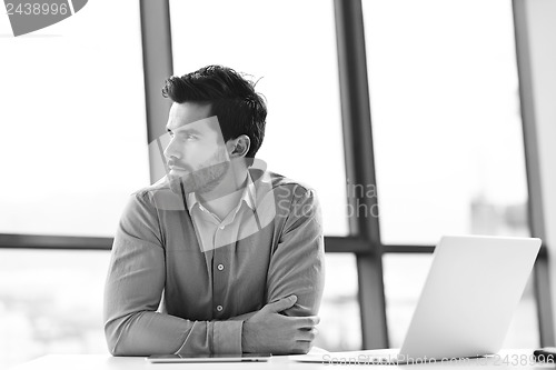 Image of happy young business man at office