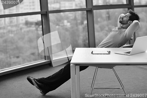 Image of happy young business man at office