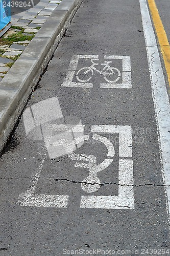 Image of Road marking for disabled people and a bicycle path.