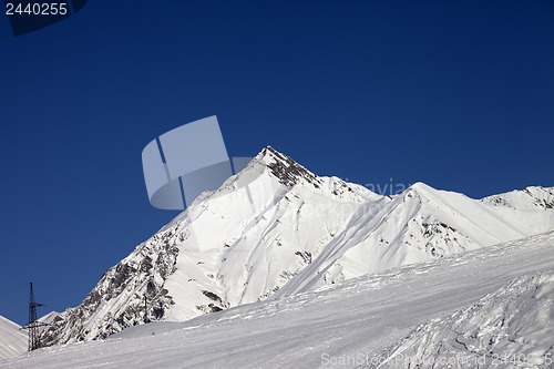 Image of Ski slope and blue clear sky at sunny day