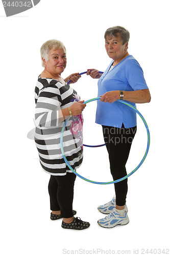 Image of Senior lady doing gymnastic with hula hoop