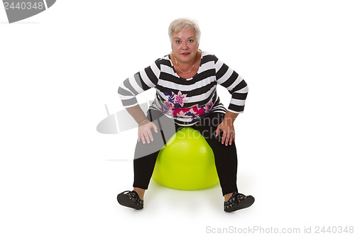 Image of Female senior sitting on swiss ball