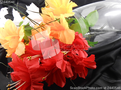 Image of White, red and yellow flowers on glass vase