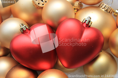 Image of red heart shaped christmas ornaments