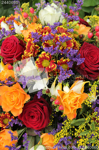 Image of Mixed floral arrangement in yellow, red and white