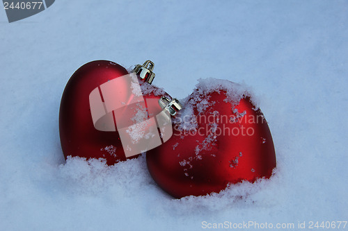 Image of Two red hearts in the snow