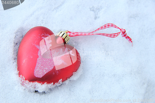 Image of Heart shaped ornament in the snow