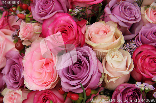 Image of purple and pink roses wedding arrangement