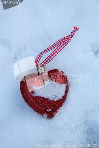 Image of Heart shaped ornament in the snow