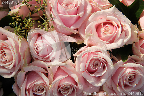 Image of Pink roses in a wedding centerpiece