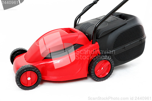 Image of new red lawnmower on white background