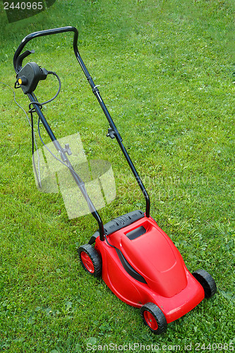 Image of new lawnmower on green grass