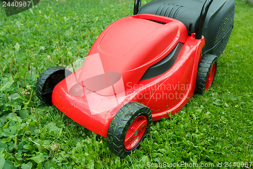 Image of new lawnmower on green grass