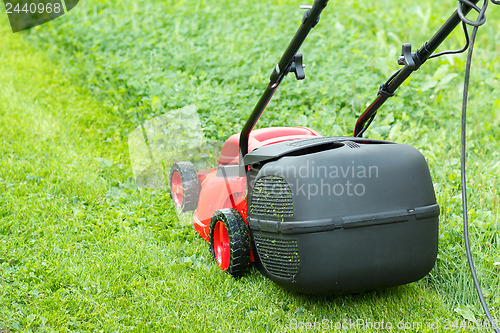 Image of new lawnmower on green grass