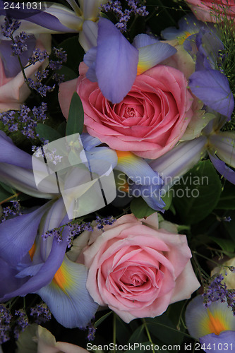 Image of Blue irises and pink roses in bridal arrangement