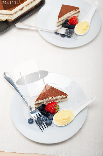 Image of tiramisu dessert with berries and cream