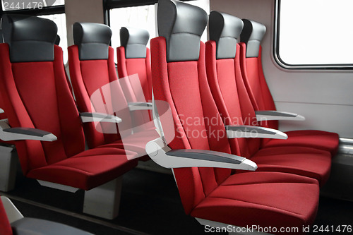 Image of rows of red seats in train