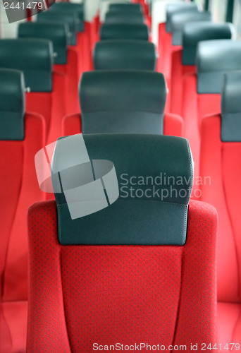 Image of rows of red seats in train
