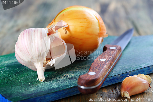 Image of Onions, garlic and a knife.