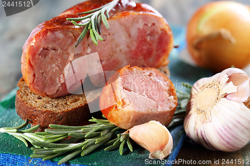 Image of Home sausage,rye bread, garlic and rosemary.