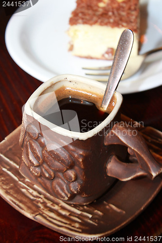 Image of cup of coffee and portion cake