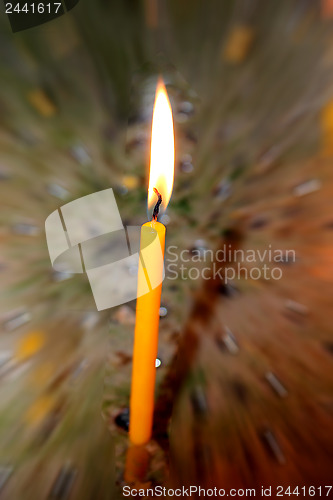 Image of Candle burning in darkness