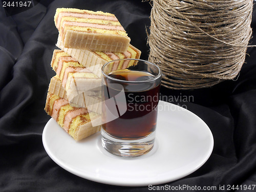 Image of Champagne, glasses and cake on black material