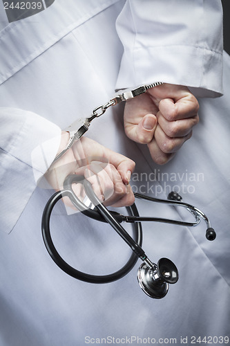 Image of Female Doctor or Nurse In Handcuffs Holding Stethoscope