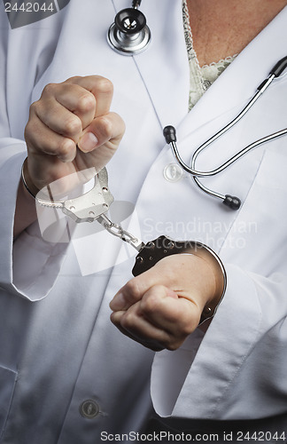 Image of Doctor or Nurse In Handcuffs Wearing Lab Coat and Stethoscope