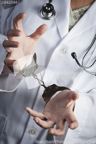 Image of Doctor or Nurse In Handcuffs Wearing Lab Coat and Stethoscope