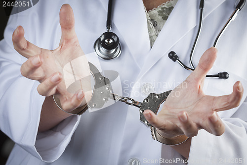 Image of Doctor or Nurse In Handcuffs Wearing Lab Coat and Stethoscope