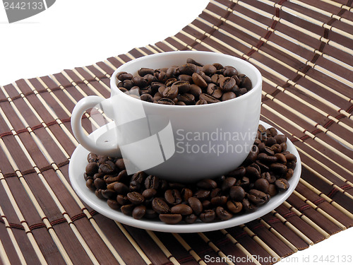 Image of Coffee beans with coffee on bamboo background