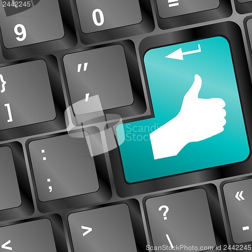 Image of like hand on blue button on keyboard