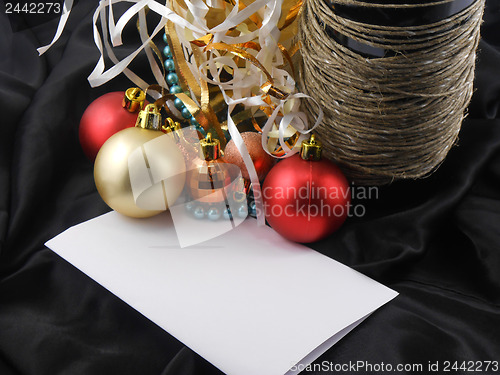 Image of bottle champagne wine with christmas balls and blank invitation paper