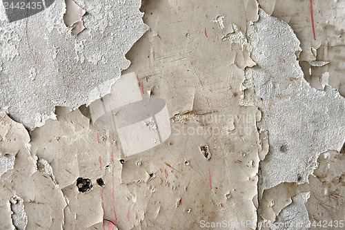 Image of White peeling paint on the wall closeup photo