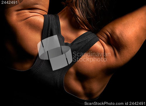 Image of Upper body of a muscular woman from the back