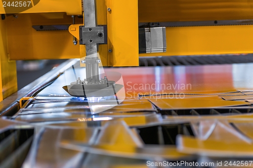 Image of Machine cutting steel in a factory