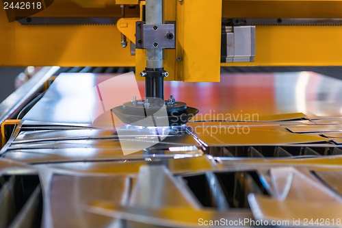 Image of Machine cutting steel in a factory