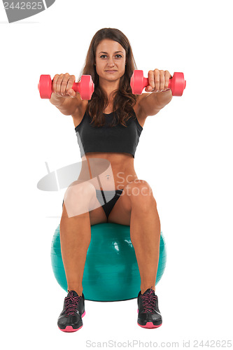 Image of Young woman in the studio with weights