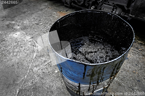 Image of Damaged oil drums in industrial interior