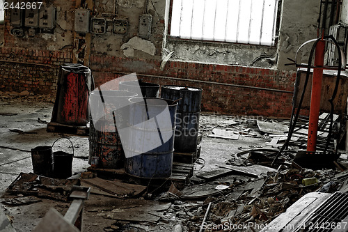 Image of Damaged oil drums in industrial interior